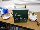 The Exodus Project by Ayin Es, making a cardboard car battery