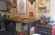 Mixed media artist, Ayin Es, rubber soul studio, paint brushes on a red art cart