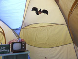 Camp Up To Now installation by Ayin Es, interior tent with hanging bat