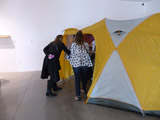 Camp Up To Now installation by Ayin Es, exterior tent with people going inside