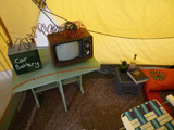 Camp Up To Now installation by Ayin Es, interior tent with tv, car battery, ants, snake and Torah